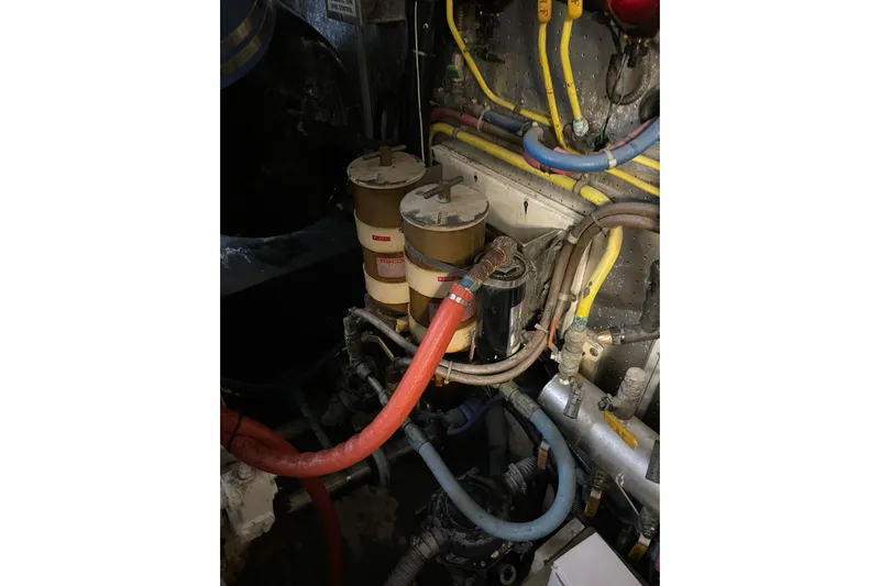"fortunate" Yacht Photos Pics Engine room of 1995 JOHNSON 65 Flybridge Motoryacht with fuel filters and hoses.