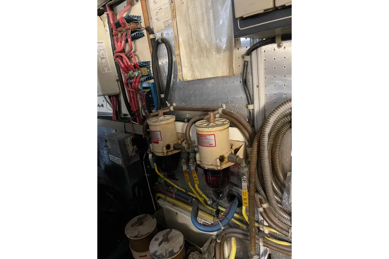 "fortunate" Yacht Photos Pics Engine room of 1995 JOHNSON 65 Flybridge Motoryacht with wiring and fuel filters.