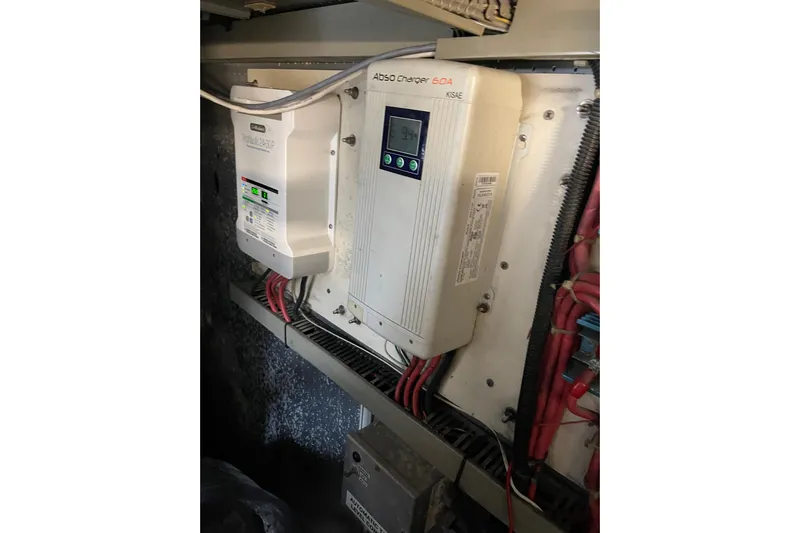 "fortunate" Yacht Photos Pics Electrical system inside a 1995 JOHNSON 65 Flybridge Motoryacht, featuring chargers and wiring.