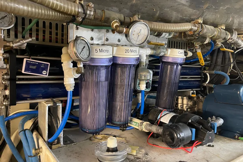 "fortunate" Yacht Photos Pics Engine room of 1995 Johnson Flybridge Motoryacht with water filtration system and gauges.