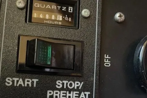 "fortunate" Yacht Photos Pics Control panel of a 1995 Johnson Flybridge Motoryacht with hour meter and switches.