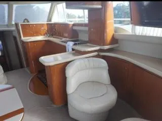  Yacht Photos Pics Luxurious interior of 2004 Sea Ray 480 Sedan Bridge yacht with elegant seating and kitchen area.
