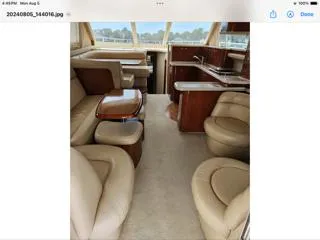  Yacht Photos Pics Luxurious interior of 2004 Sea Ray 480 Sedan Bridge yacht with leather seating and wooden accents.