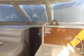  Yacht Photos Pics Interior of 2004 Sea Ray 480 Sedan Bridge yacht with beige seating and wooden cabinetry.