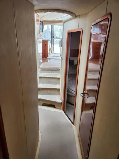  Yacht Photos Pics Interior hallway of 2004 Sea Ray 480 Sedan Bridge yacht, featuring stairs and cabin doors.