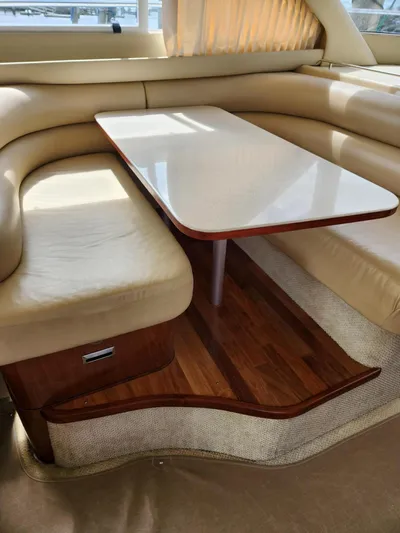  Yacht Photos Pics Luxurious interior of 2004 Sea Ray 480 Sedan Bridge with elegant seating and table.