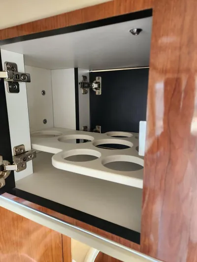  Yacht Photos Pics 2004 Sea Ray 480 Sedan Bridge cabinet with cup holders and wooden finish.