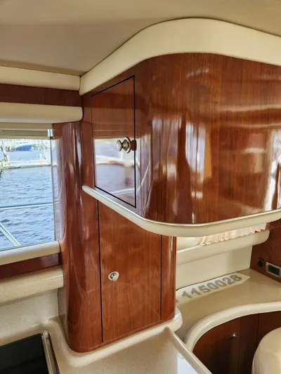  Yacht Photos Pics 2004 Sea Ray 480 Sedan Bridge interior with polished wood cabinetry and window view.