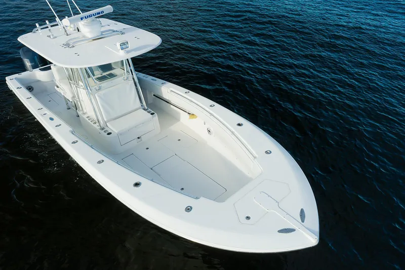 Dominion Yacht Photos Pics 2007 Invincible 33 Open Fisherman boat on calm blue water.