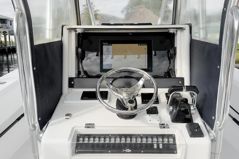 Dominion Yacht Photos Pics Console of 2007 Invincible 33 Open Fisherman with steering wheel and navigation display.