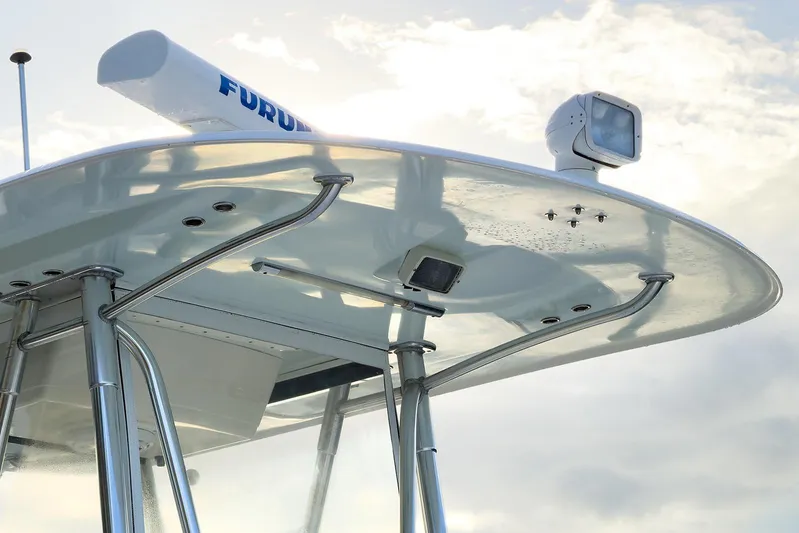 Dominion Yacht Photos Pics 2007 Invincible 33 Open Fisherman boat's radar and T-top against a cloudy sky.