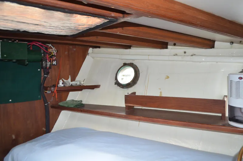 Drakus Yacht Photos Pics Interior of 1973 Skookum Ketch with wooden beams and porthole window.