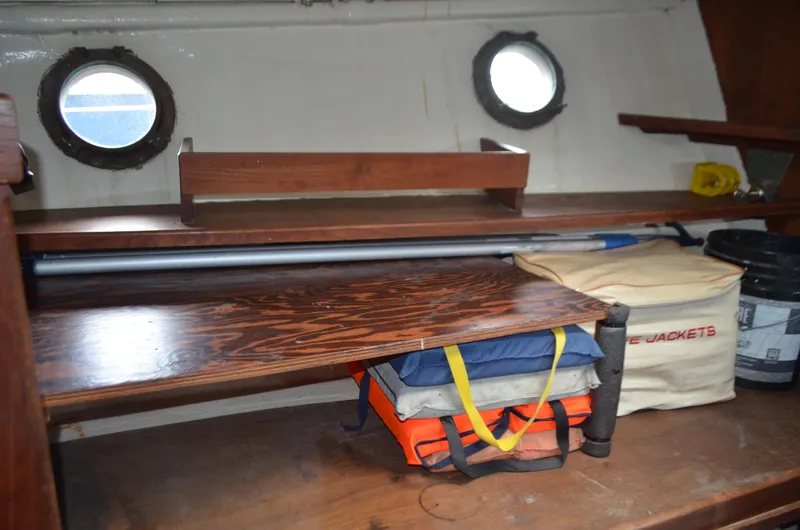 Drakus Yacht Photos Pics Interior of 1973 Skookum Ketch with life jackets and wooden shelves.