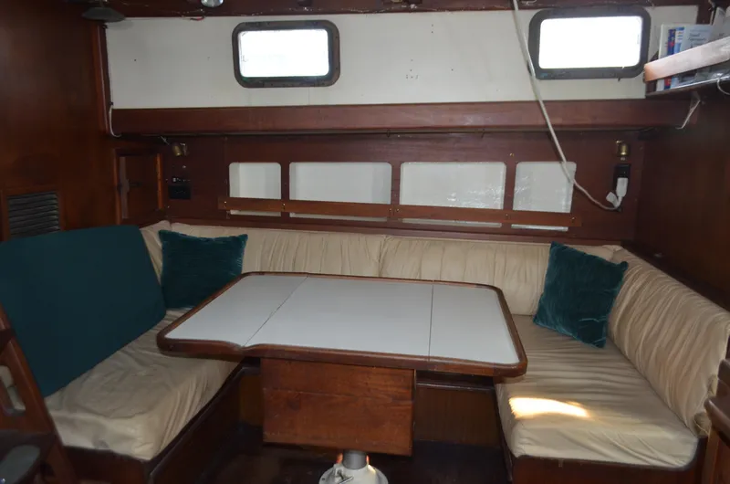 Drakus Yacht Photos Pics 1973 Skookum Ketch interior with cozy seating and wooden table.