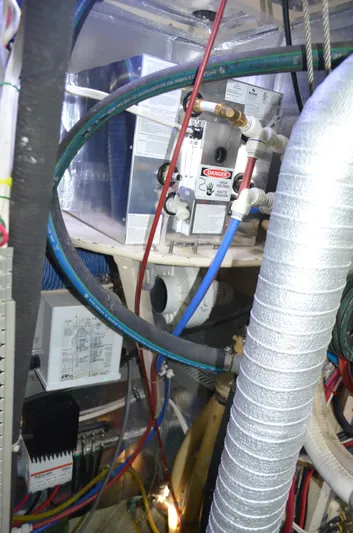 Drakus Yacht Photos Pics Engine room of a 1973 Skookum Ketch with various pipes and equipment.