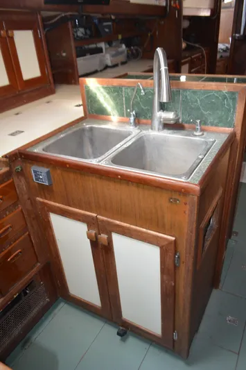 Drakus Yacht Photos Pics 1973 Skookum Ketch kitchen sink with dual basins and wooden cabinetry.