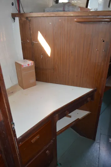 Drakus Yacht Photos Pics 1973 Skookum Ketch interior with wooden desk and storage drawers.