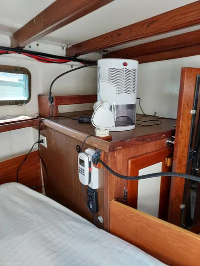 Drakus Yacht Photos Pics Interior of a 1973 Skookum Ketch boat with wooden cabinetry and modern appliances.