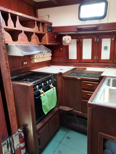 Drakus Yacht Photos Pics 1973 Skookum Ketch kitchen with wooden cabinetry and modern appliances.