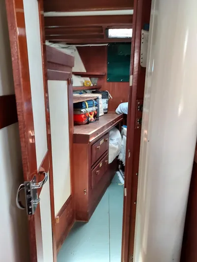 Drakus Yacht Photos Pics Interior view of a 1973 Skookum Ketch sailboat cabin with wooden cabinetry.