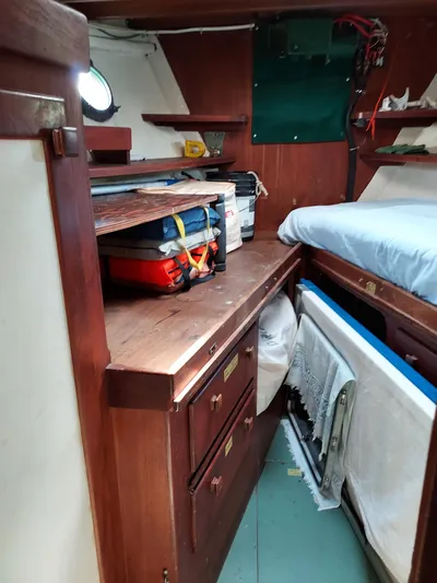 Drakus Yacht Photos Pics 1973 Skookum Ketch interior with wooden cabinetry and storage space.