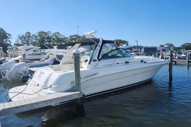  Yacht Photos Pics 2002 Sea Ray 410 Sundancer yacht docked at marina on a sunny day.