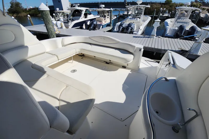  Yacht Photos Pics Luxurious 2002 Sea Ray 410 Sundancer yacht interior with spacious seating and docked boats in background.