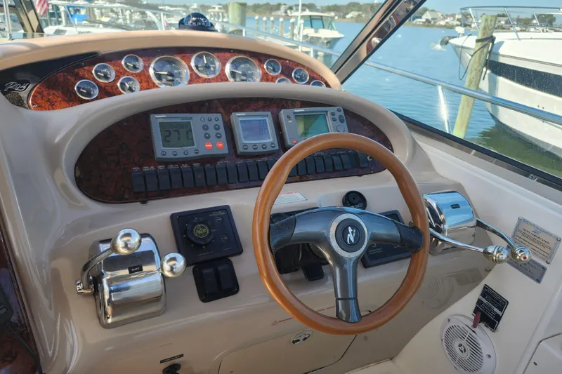  Yacht Photos Pics Cockpit of 2002 Sea Ray 410 Sundancer with steering wheel and control panel.