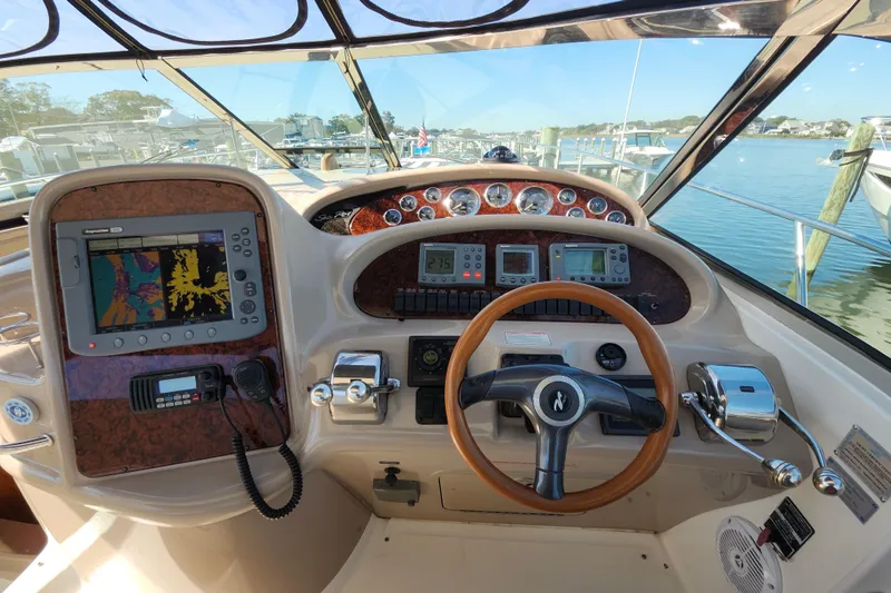  Yacht Photos Pics Helm of 2002 Sea Ray 410 Sundancer with navigation equipment and steering wheel.