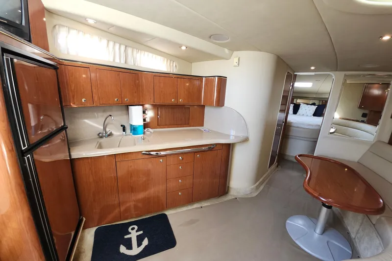  Yacht Photos Pics Interior of 2002 Sea Ray 410 Sundancer yacht with kitchen and seating area.