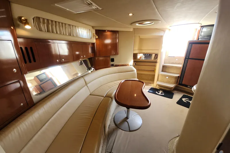  Yacht Photos Pics Luxurious interior of 2002 Sea Ray 410 Sundancer yacht with elegant seating and wooden finishes.
