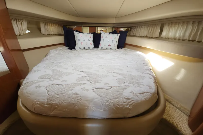  Yacht Photos Pics Luxurious cabin interior of 2002 Sea Ray 410 Sundancer yacht with cozy bedding.