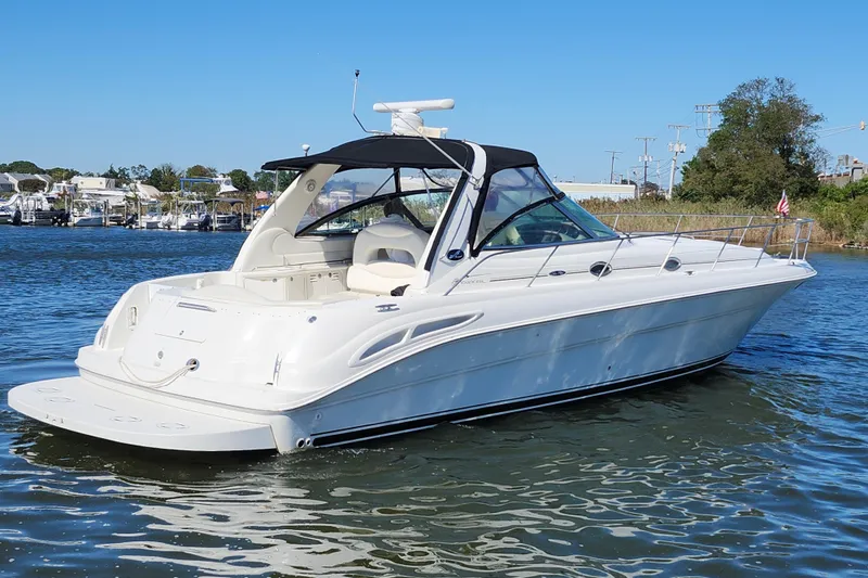  Yacht Photos Pics 2002 Sea Ray 410 Sundancer yacht on calm water, featuring sleek design and spacious deck.