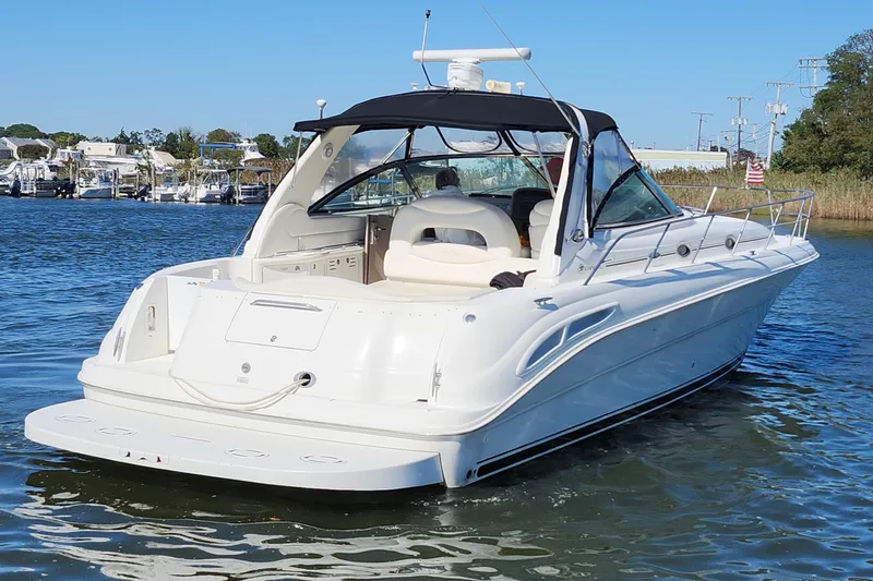  Yacht Photos Pics 2002 Sea Ray 410 Sundancer yacht on calm water, featuring sleek white design.