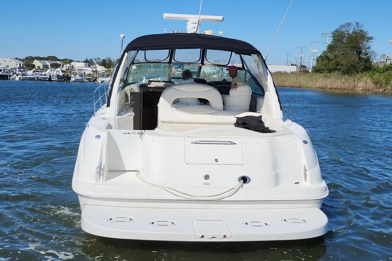  Yacht Photos Pics 2002 Sea Ray 410 Sundancer yacht cruising on a sunny day, rear view.