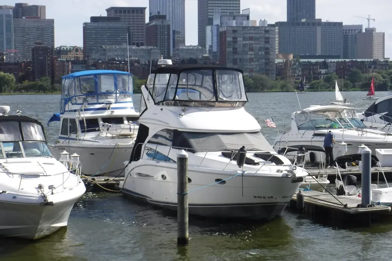  Yacht Photos Pics 2007 Meridian 341 Sedan yacht docked in urban marina with city skyline backdrop.