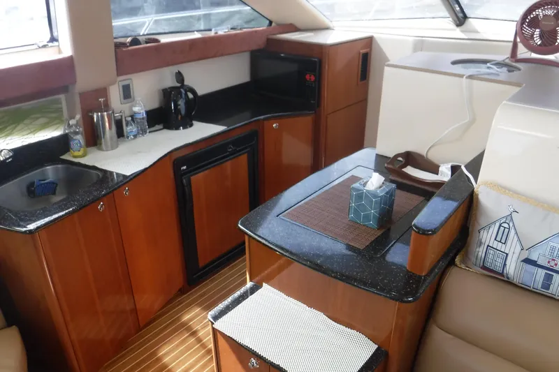  Yacht Photos Pics Luxurious interior of a 2007 Meridian 341 Sedan yacht with kitchenette and seating area.