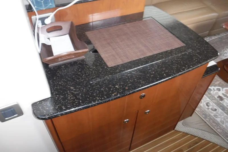  Yacht Photos Pics 2007 Meridian 341 Sedan interior with sleek black countertop and wooden cabinetry.