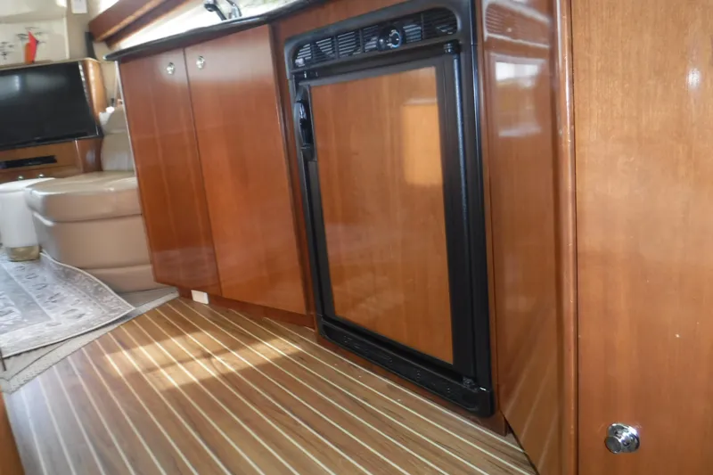  Yacht Photos Pics 2007 Meridian 341 Sedan interior with wood cabinetry and compact refrigerator.
