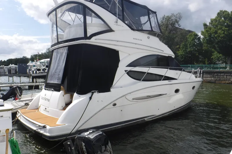  Yacht Photos Pics 2007 Meridian 341 Sedan yacht docked at marina, featuring sleek design and spacious upper deck.