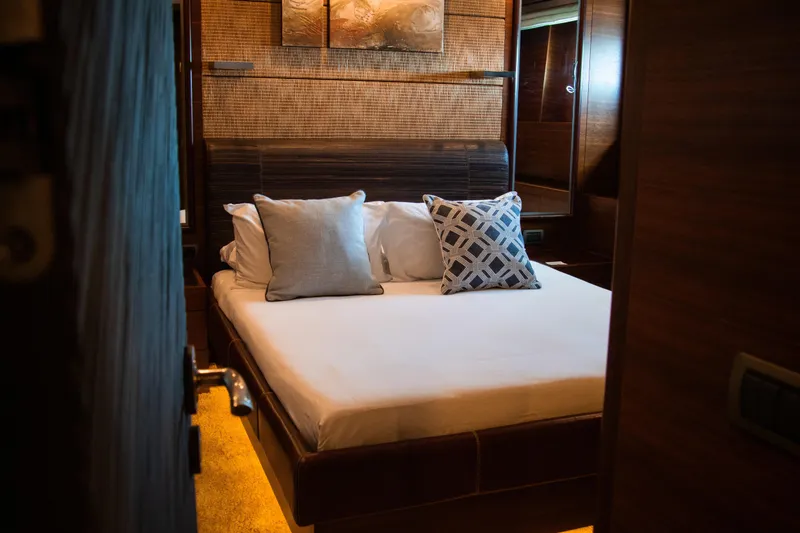 Matsu Yacht Photos Pics Luxurious bedroom interior in 2009 ISA 120 Sport yacht, featuring elegant bedding and decor.