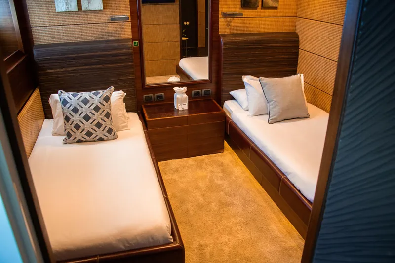 Matsu Yacht Photos Pics Luxurious twin cabin interior on 2009 ISA 120 Sport yacht, featuring elegant bedding and decor.
