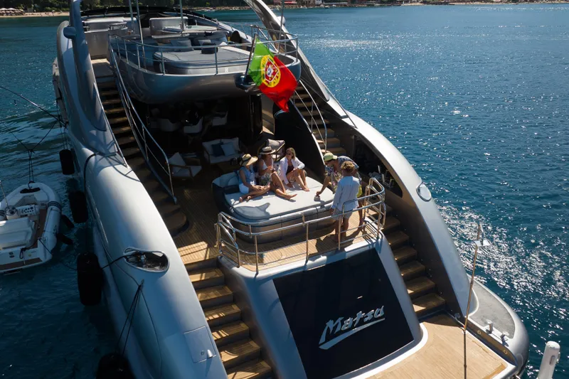 Matsu Yacht Photos Pics Luxurious 2009 ISA 120 Sport yacht with people relaxing on deck, Portuguese flag waving.