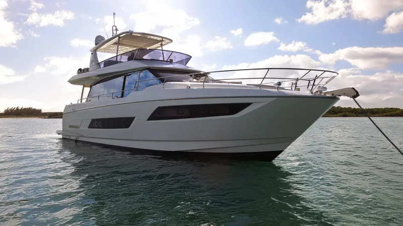 Yachtooma Yacht Photos Pics Luxury 2017 Present Yachts 680 anchored on serene water under a blue sky.