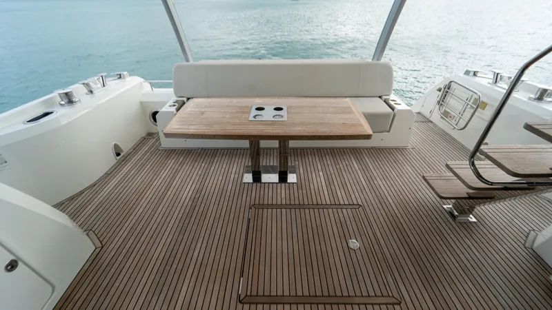 Yachtooma Yacht Photos Pics Spacious deck of 2017 Present Yachts 680 with wooden table and seating.