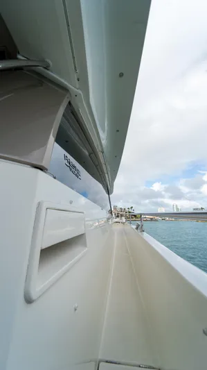 Yachtooma Yacht Photos Pics Side view of 2017 Present Yachts 680, docked with ocean and sky in background.