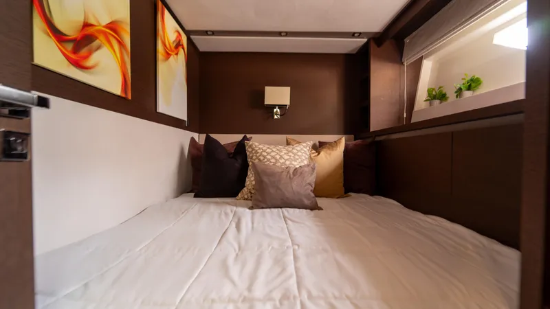 Yachtooma Yacht Photos Pics Luxurious cabin interior of 2017 Present Yachts 680 with cozy bedding and modern decor.