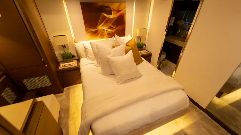 Yachtooma Yacht Photos Pics Luxurious bedroom interior on 2017 Present Yachts 680, featuring elegant decor and cozy bedding.