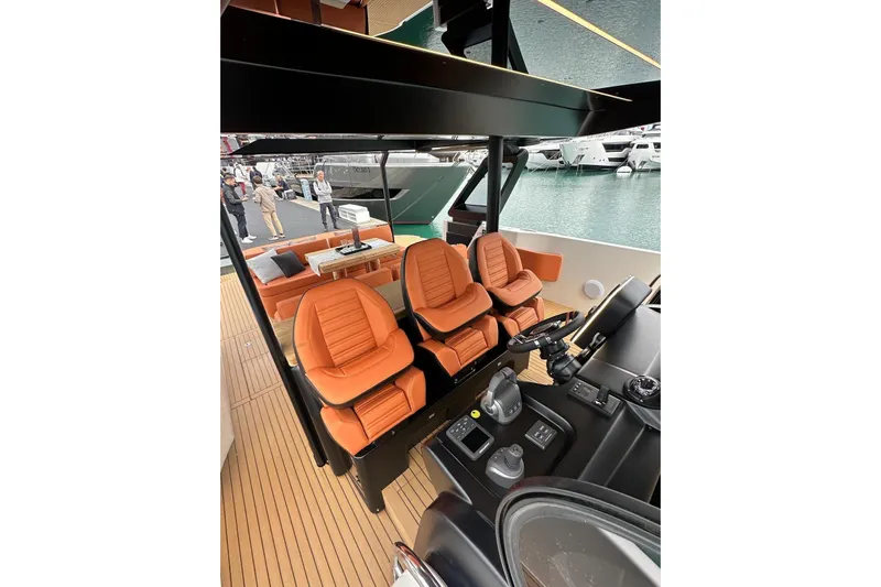  Yacht Photos Pics 2025 Cranchi A46 Luxury Tender interior with orange seats and modern controls.