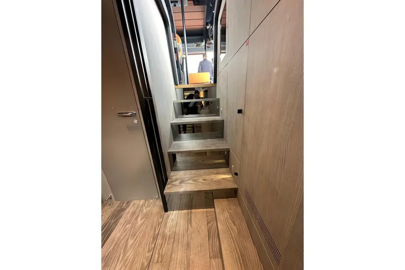  Yacht Photos Pics Interior stairs of 2025 Cranchi A46 Luxury Tender yacht, featuring modern wood design.